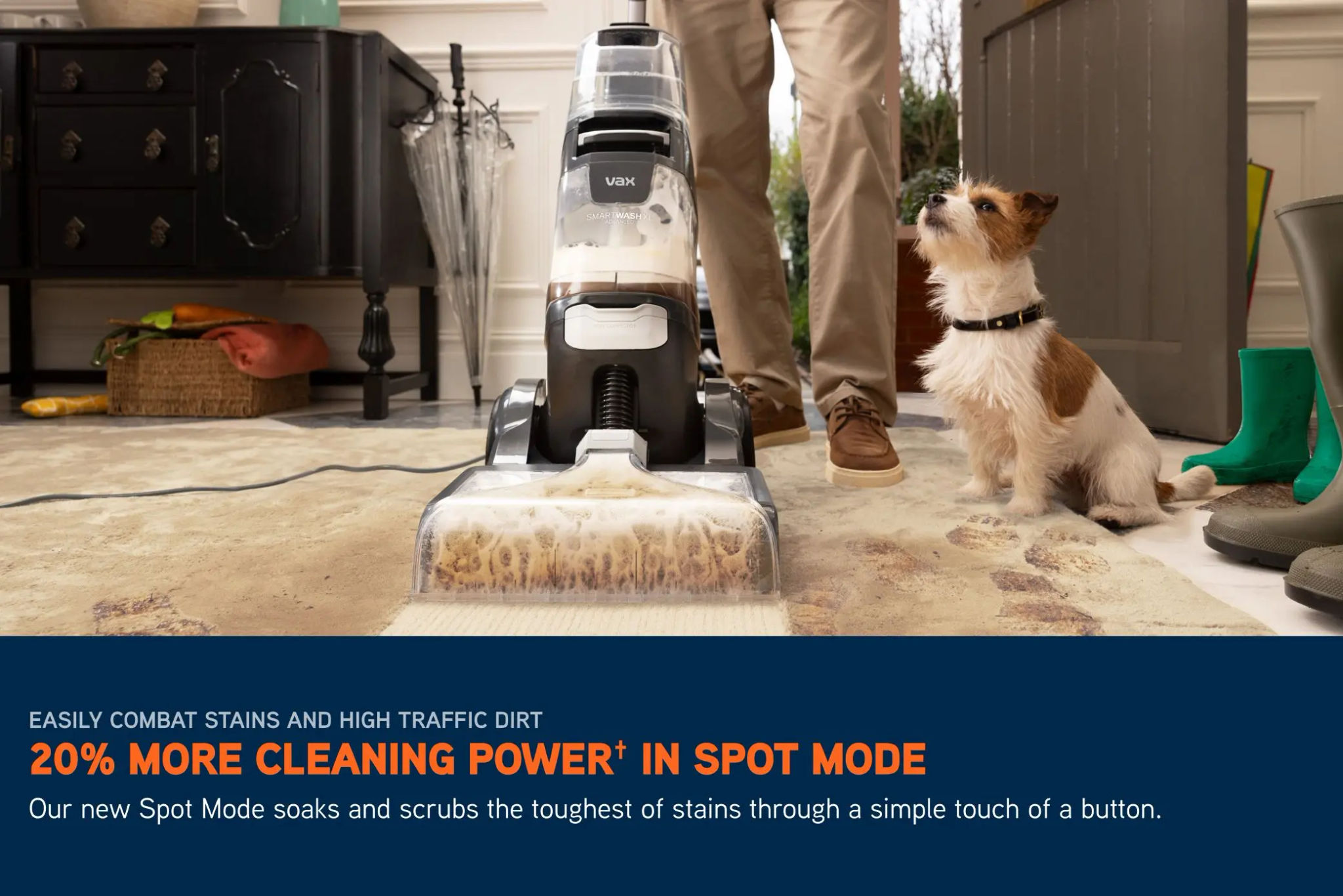 VAX SmartWash XL Advanced carpet cleaner removing muddy prints from boots out of a cream carpet, with a dog visible next to the rug. 