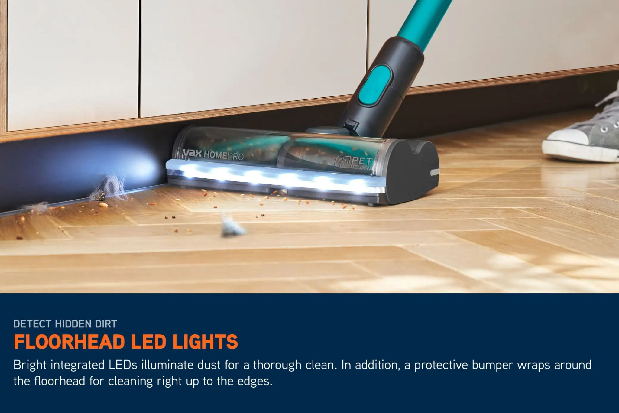 LED lights on a cordless HomePro vacuum illuminating the floor ahead, picking up crumbs and dirt on a hard floor