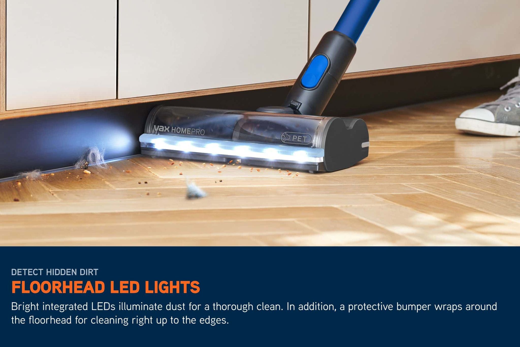 LED lights on a cordless HomePro Pet vacuum illuminating the floor ahead, picking up crumbs and dirt on a hard floor
