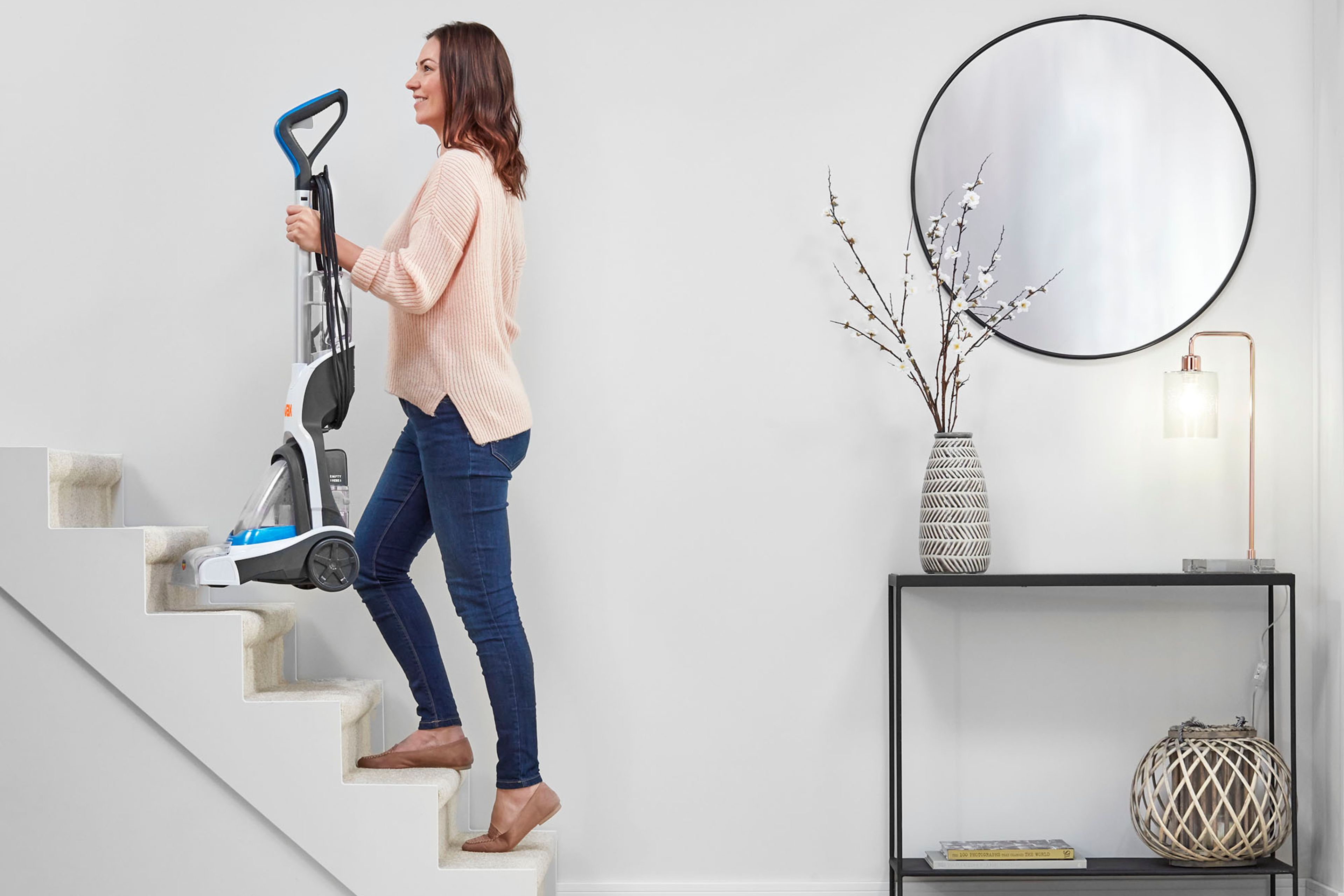 VAX Compact Power Carpet Cleaner being carried upstairs